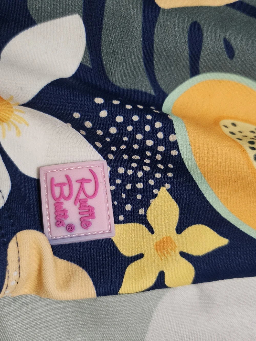Ruffle Butts Navy One-Piece Swimsuit with Yellow Fruit Print